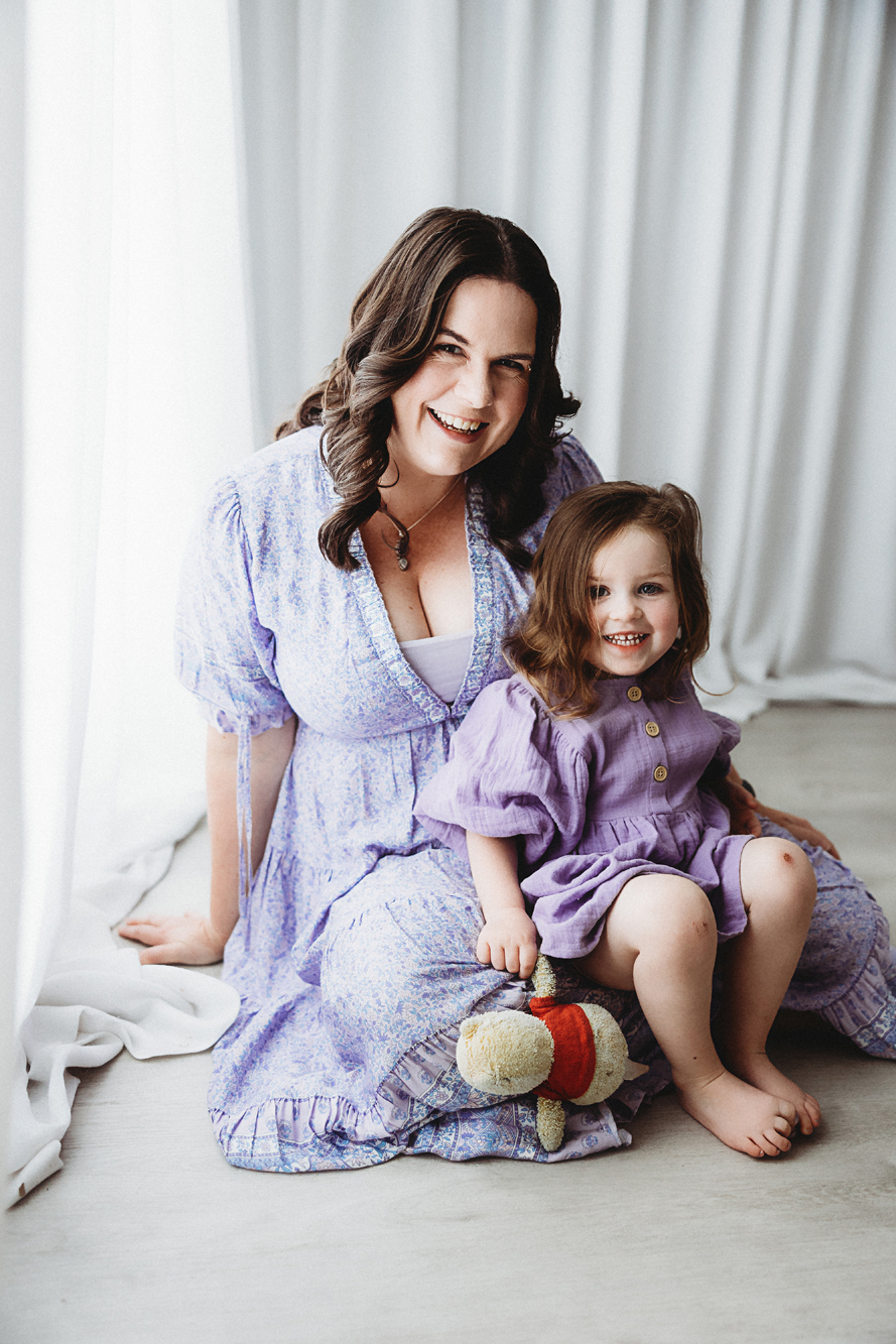canberra, mother and daughter photo connected, smiling, purple dress